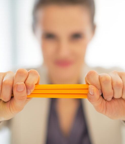 Closeup on business woman holding pencils stack